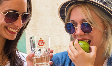 Cuban girls enjoying rum cocktail.